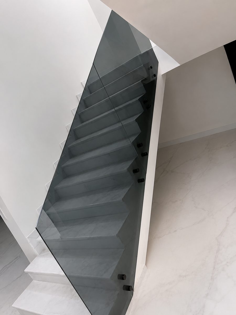 Smoked tempered-glass staircase balustrade with stainless fittings